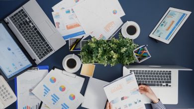 top-view-manager-woman-analyzing-financial-paperwork-strategy-typing-expertise-laptop